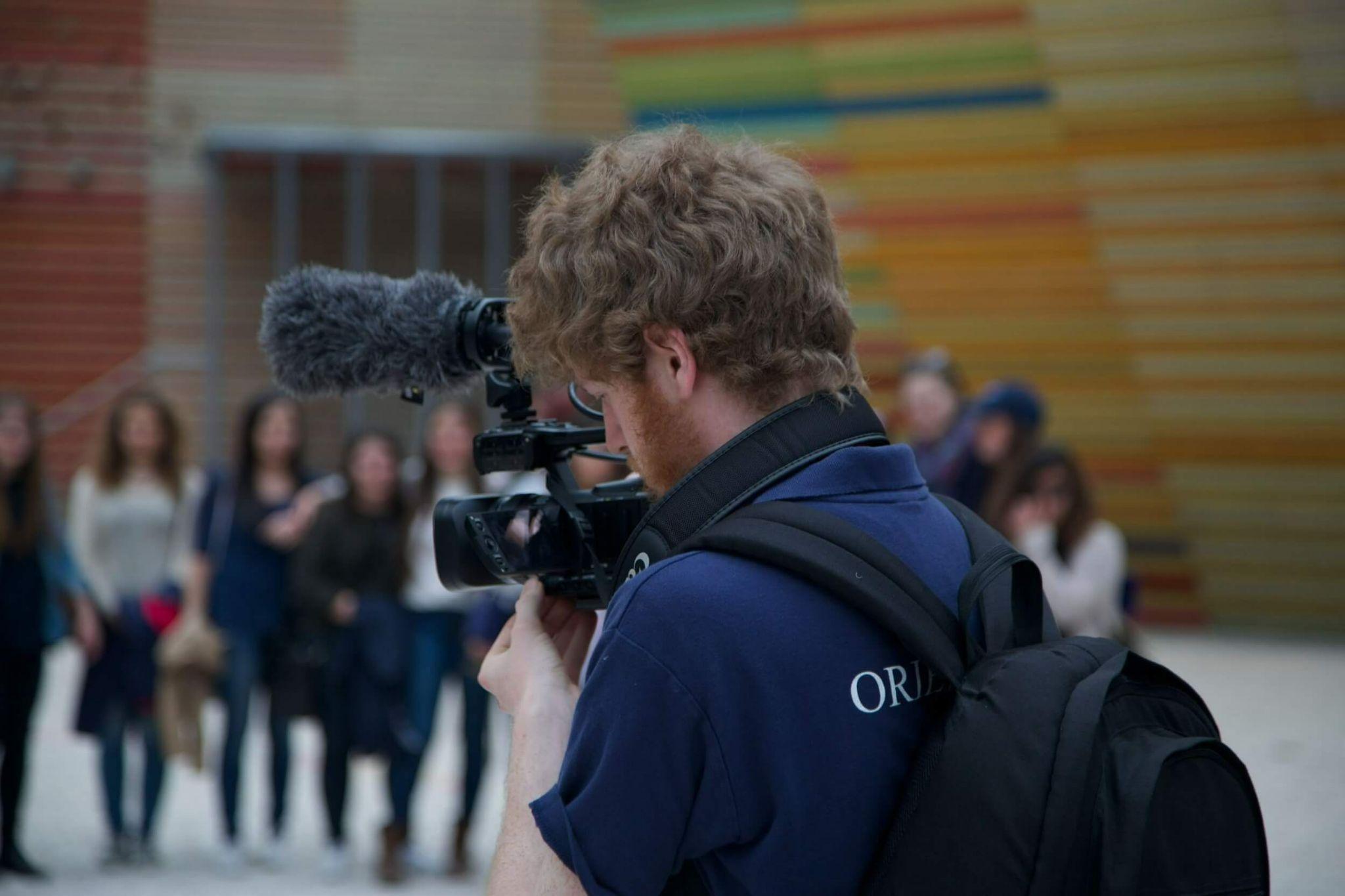 student using video camera as they study communications in Rome