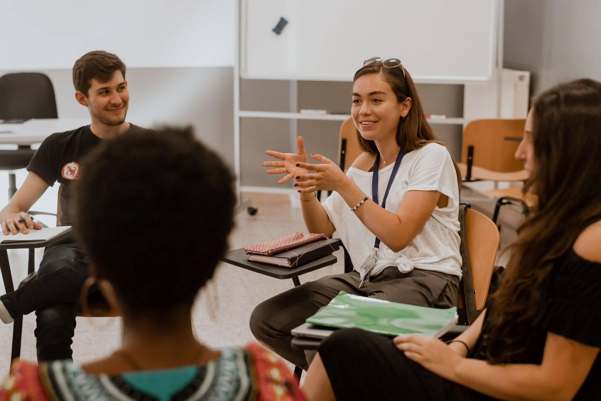 student engaging in class discussion as they study communications in Rome