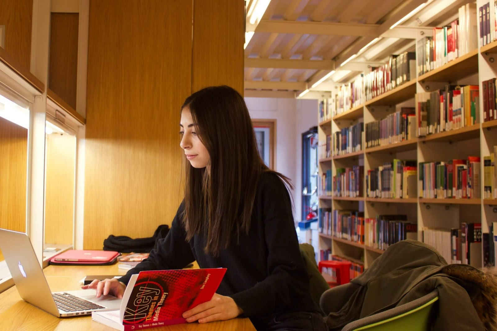 Girl minoring in legal studies at John Cabot in Italy studying in the library