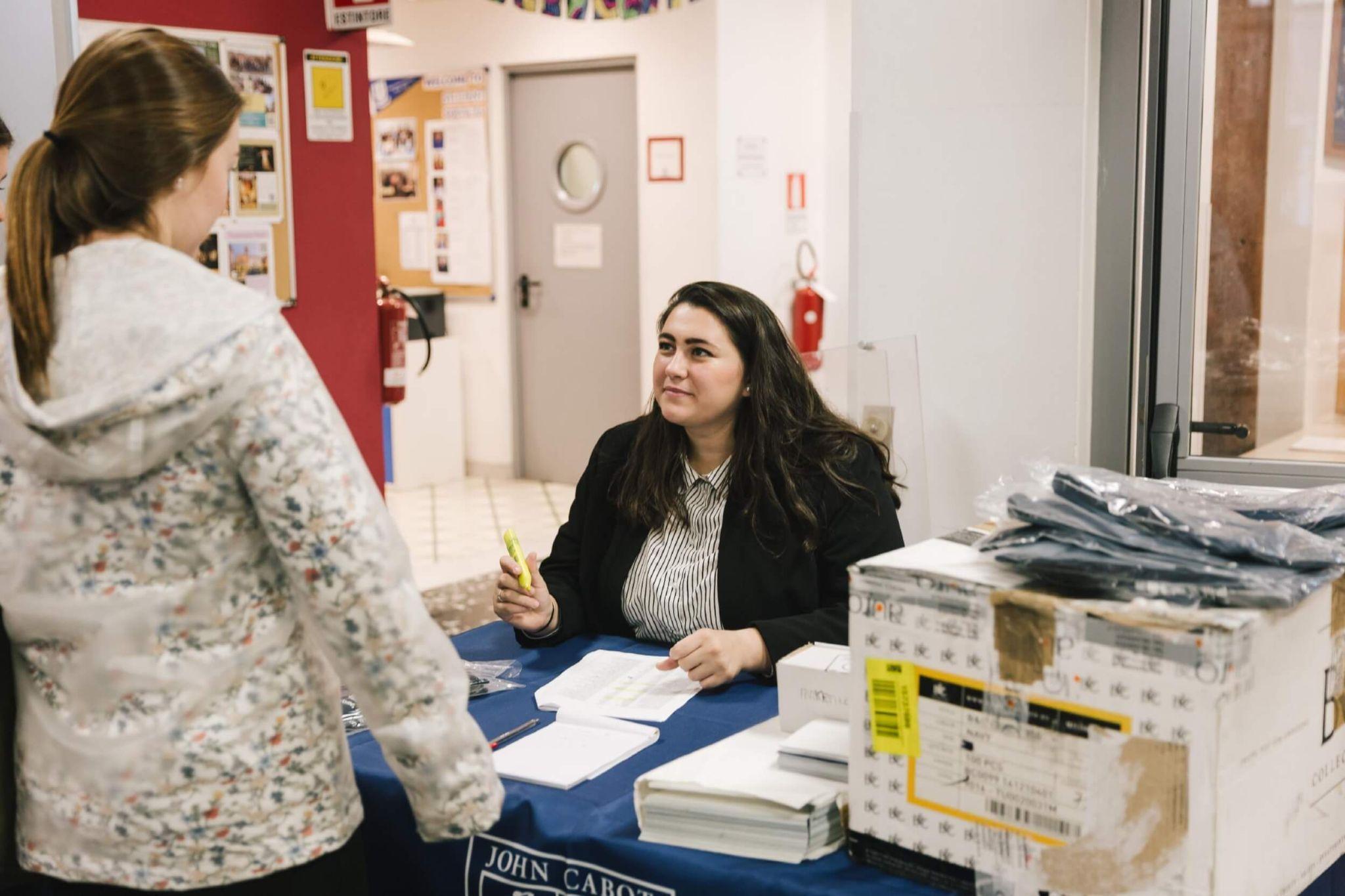 Student speaking with a staff member at John Cabot University.