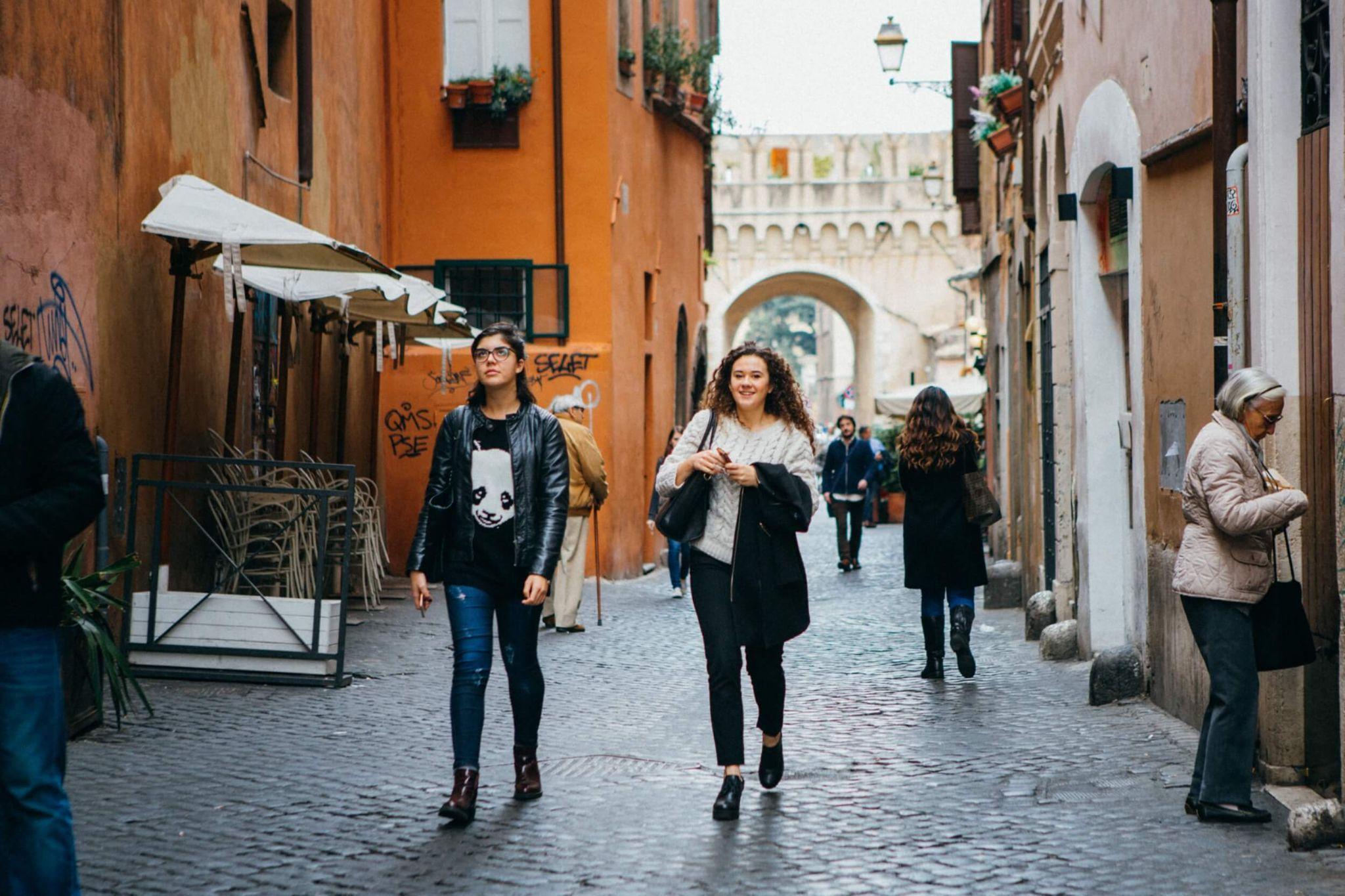 A pair of students walking in the center square shopping sustainability as they study abroad in Rome.