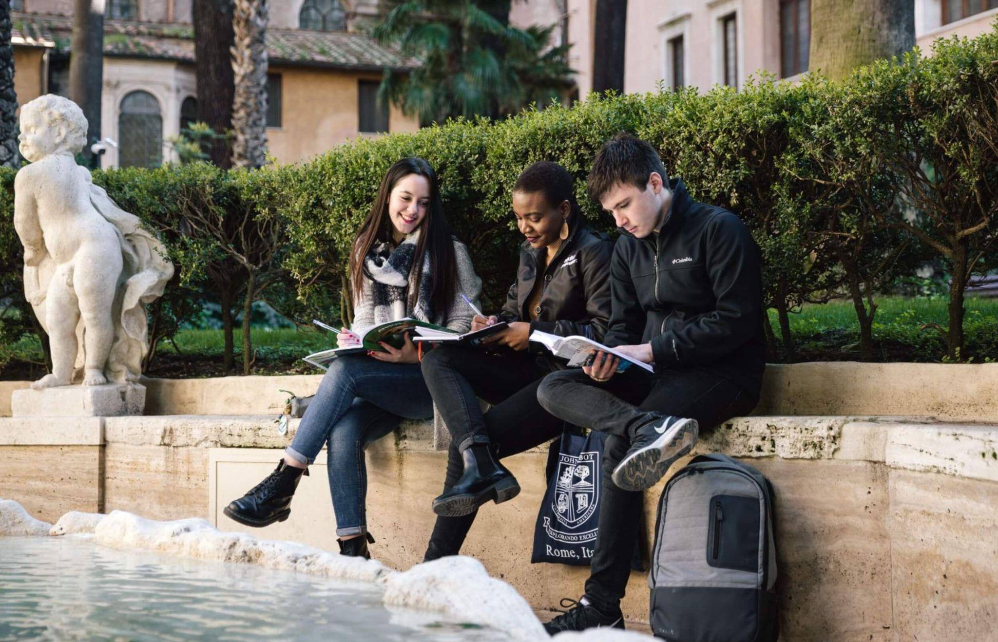 A trio of JCU students working together outside