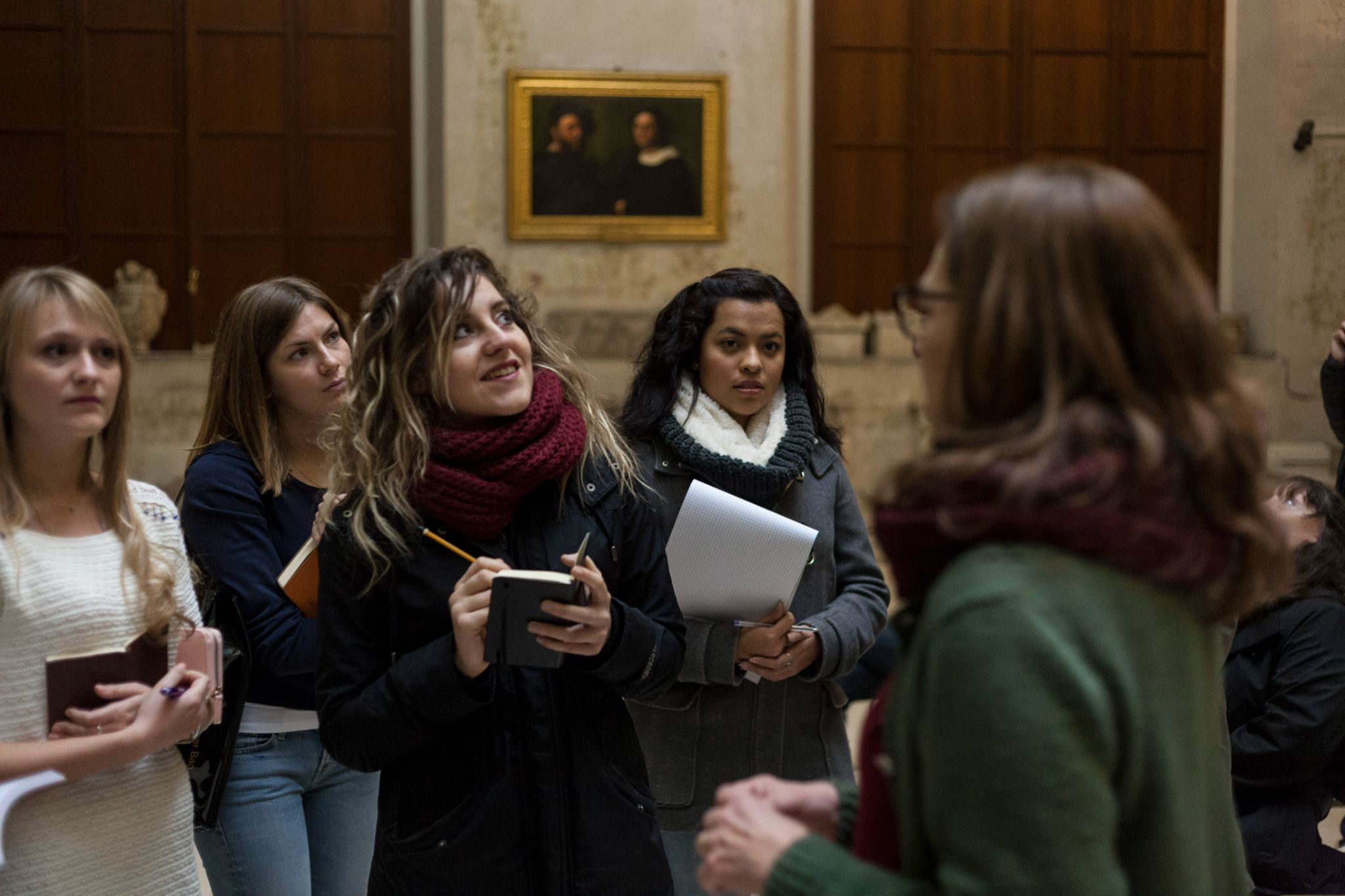 students earning an MA in art history studying art in a museum