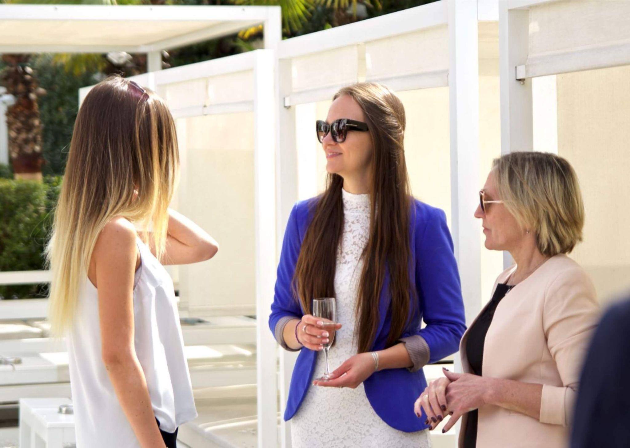 A trio of Master of Arts in International Affairs graduates networking at an outdoor event