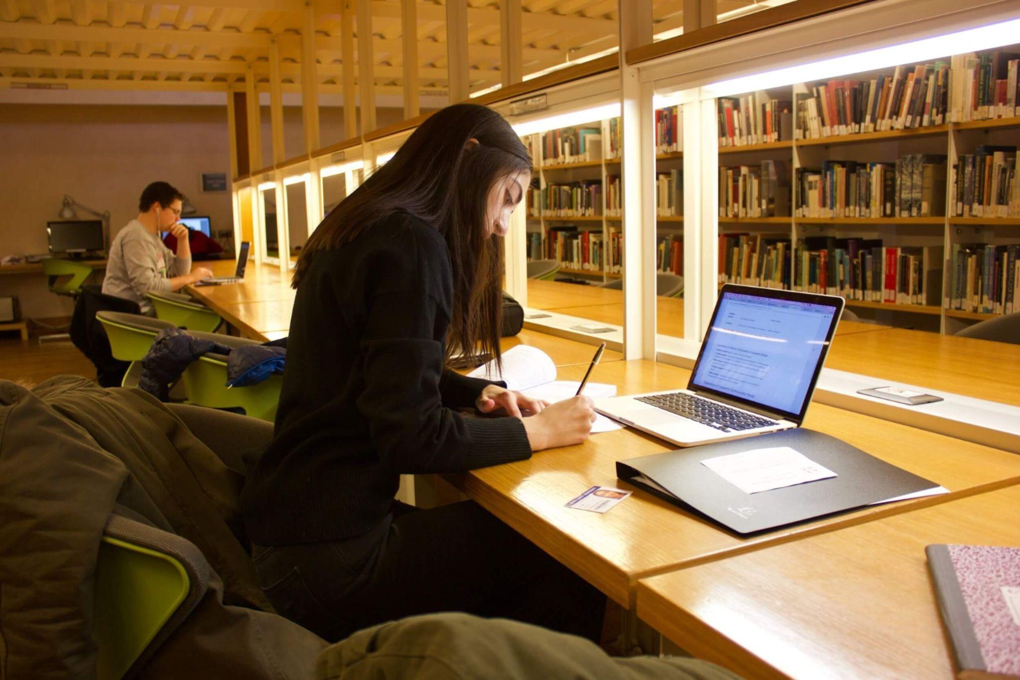 A student attending university in Rome studying in the library.