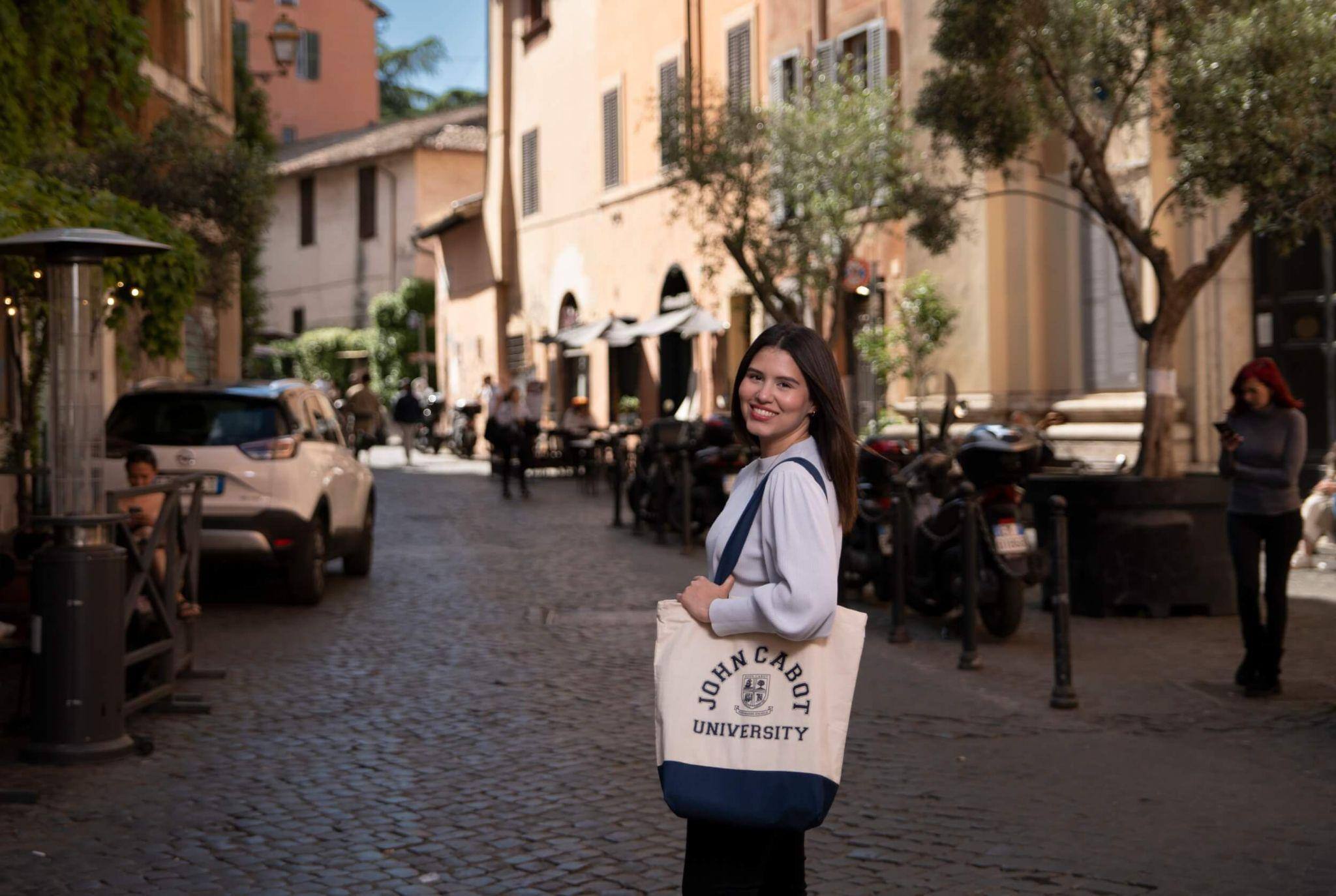 A smiling female study abroad student navigating the Trastevere in Rome