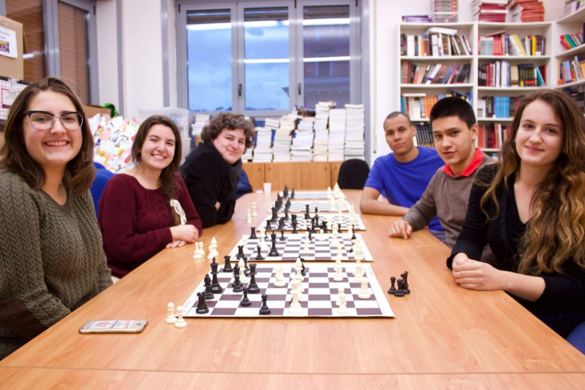 A group of  JCU students engaging in a chess tournament during chess club.