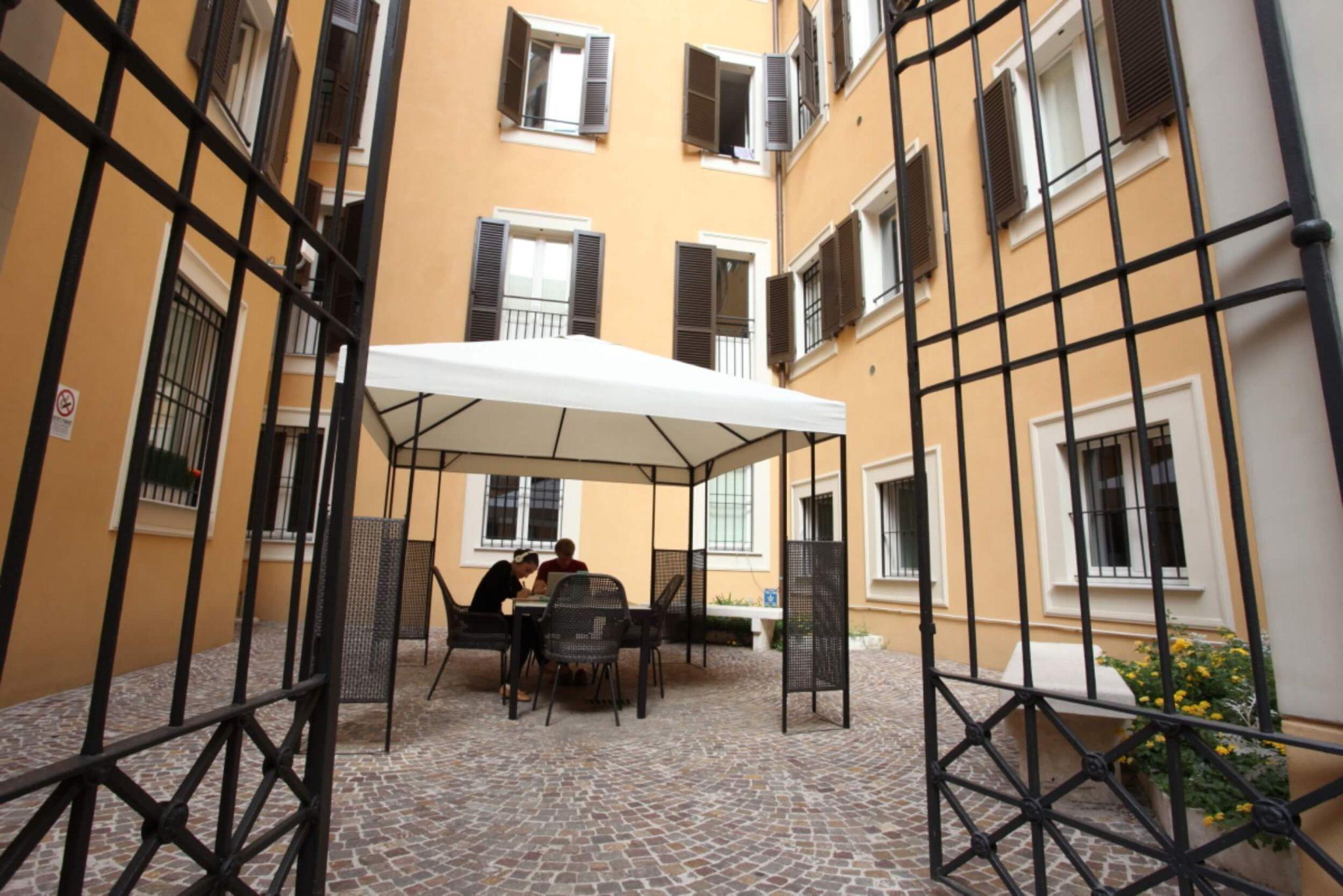 A group of JCU students studying outside of a residence