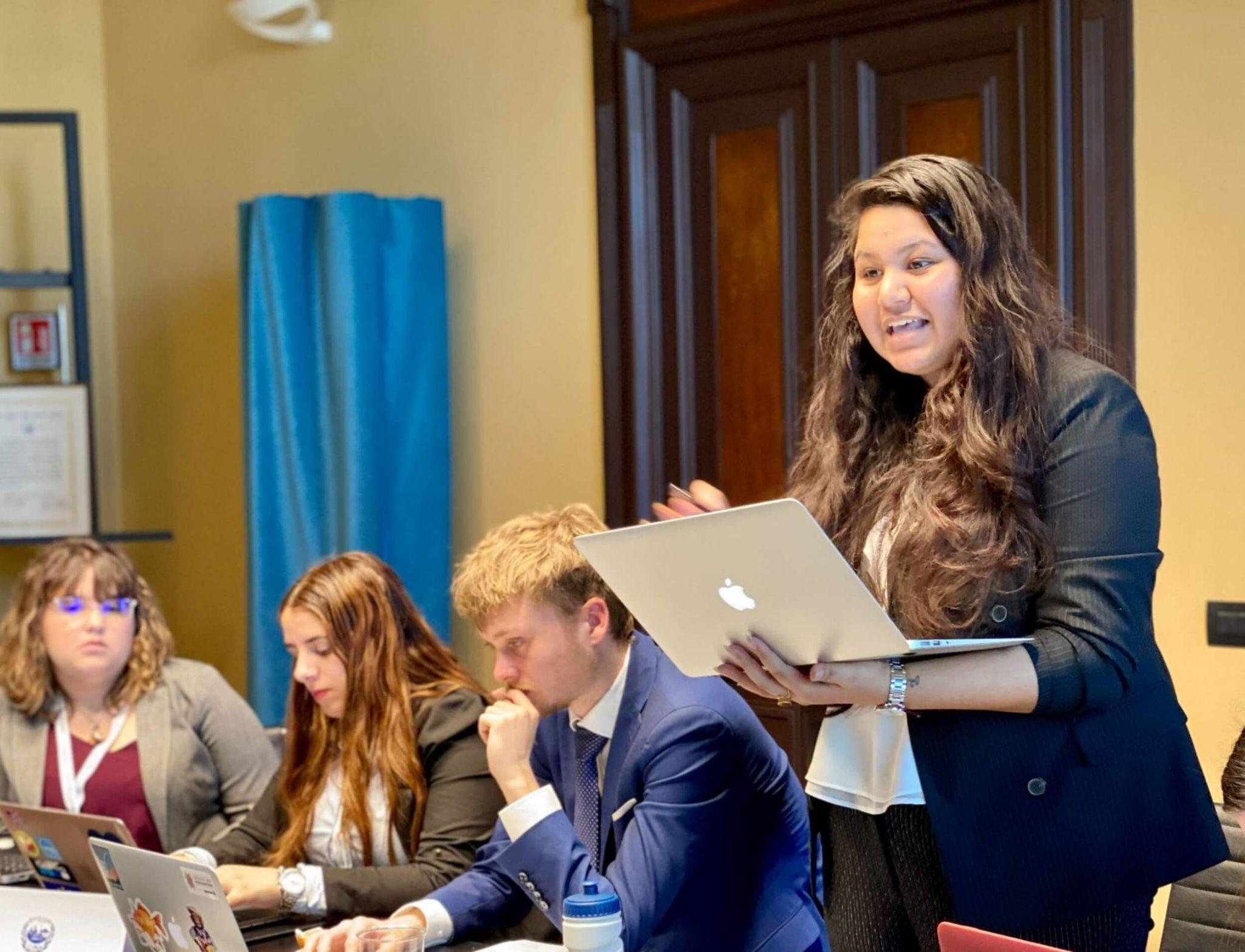 A business student at a university in Rome presenting in front of her class