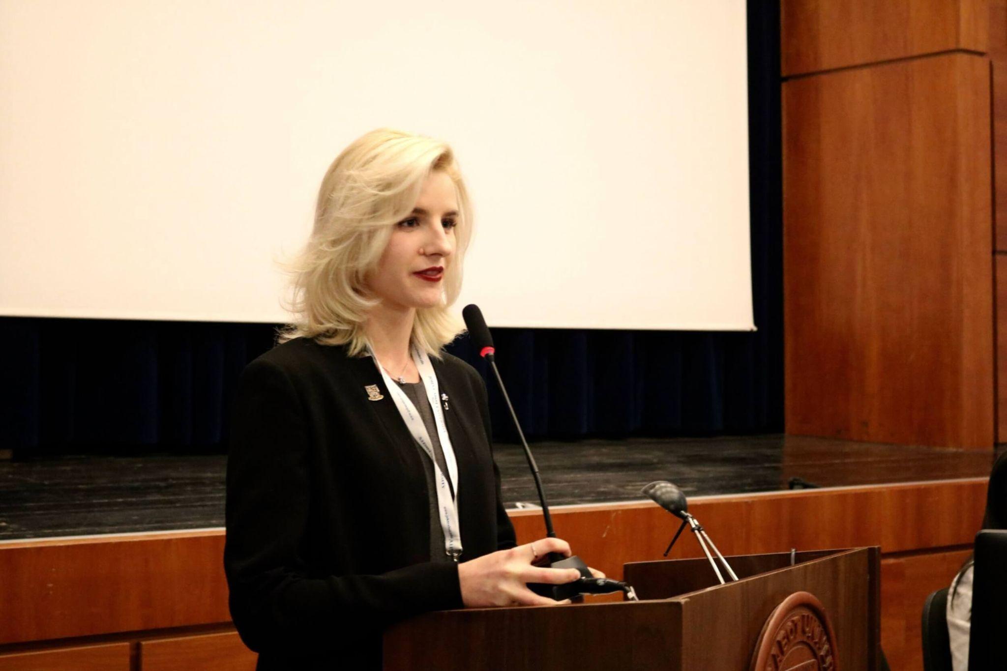 student speaking on a podium as they study international affairs in Rome