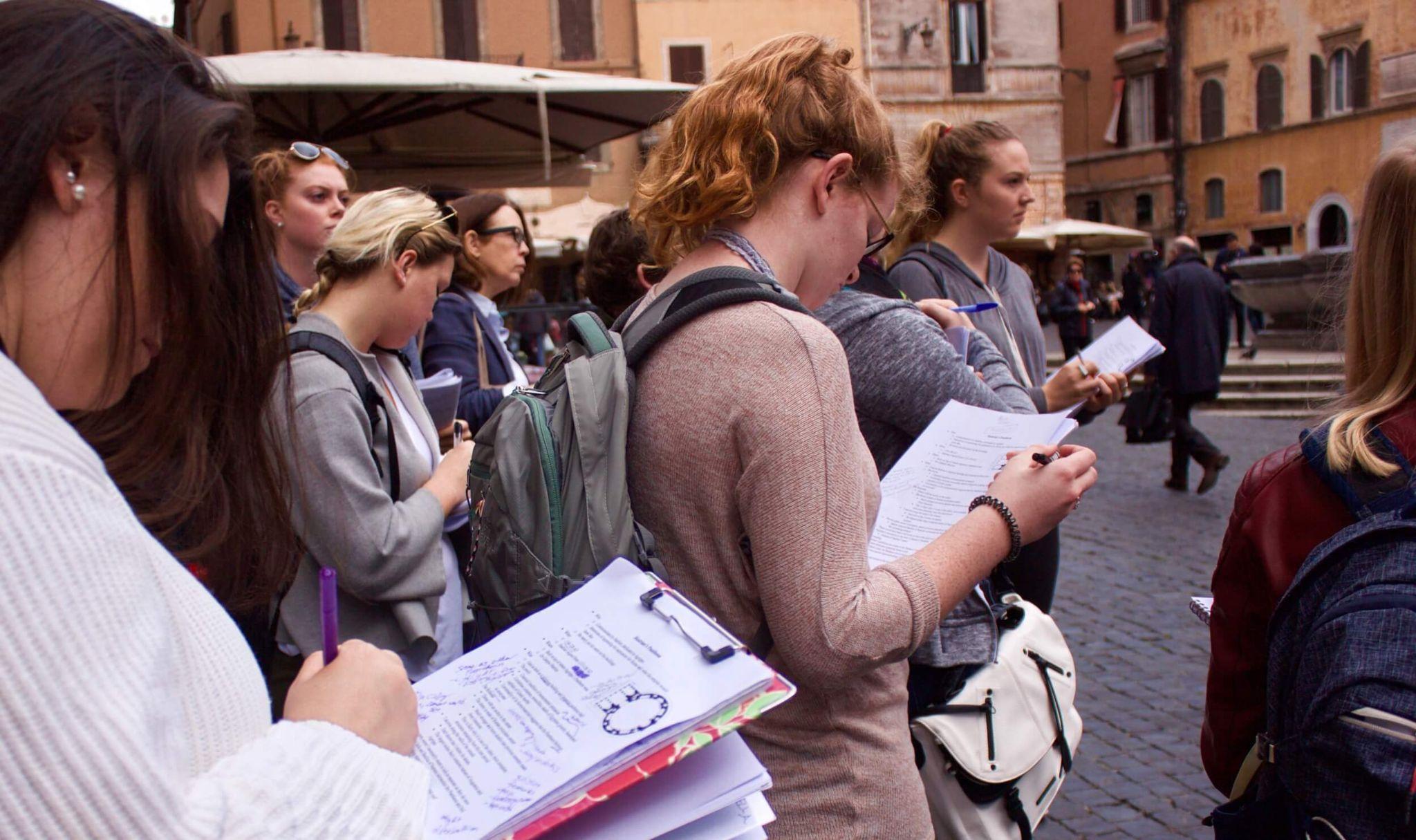 A group of students taking notes as they study abroad in Rome