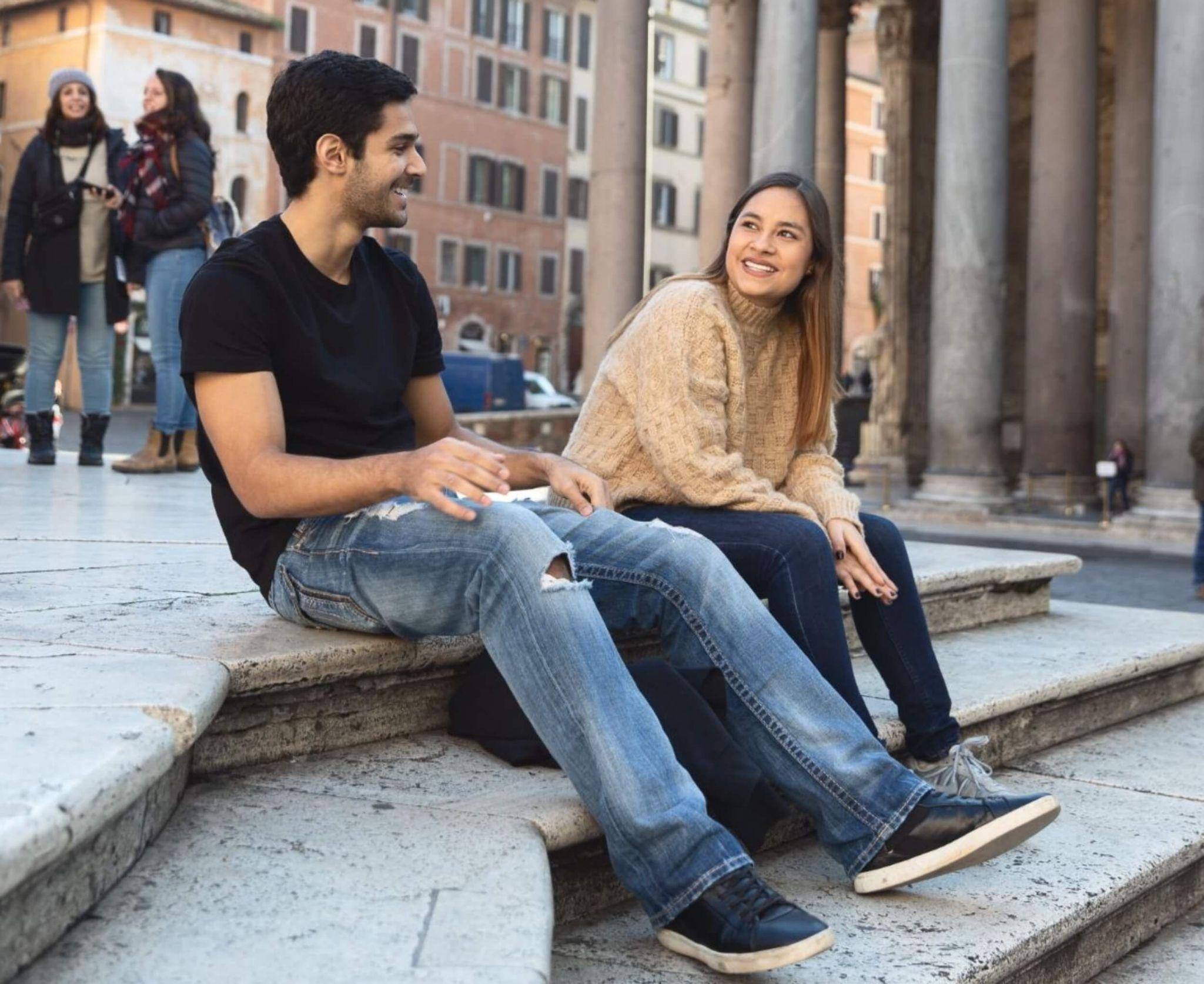 A student taking a summer engineering course speaking to a fellow student outside