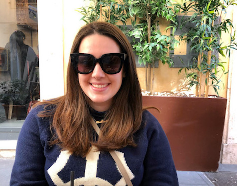 girl sitting with sunglasses in piazza