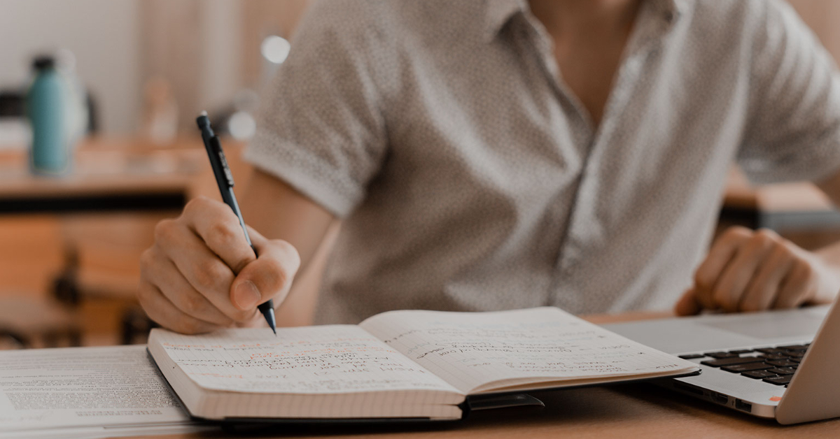 Student writing in notebook