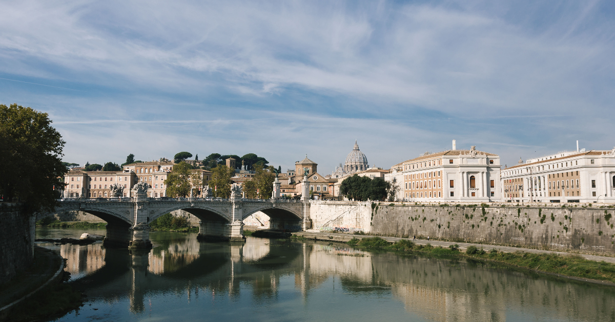 View from a bridge of the Tiber river with the Vatican in the background