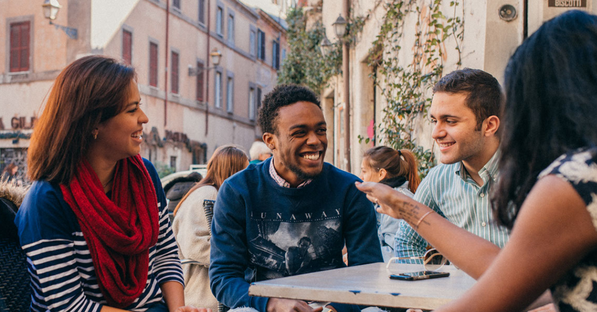 Students laughing around a table