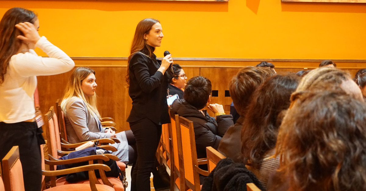 Woman speaking from a crowd