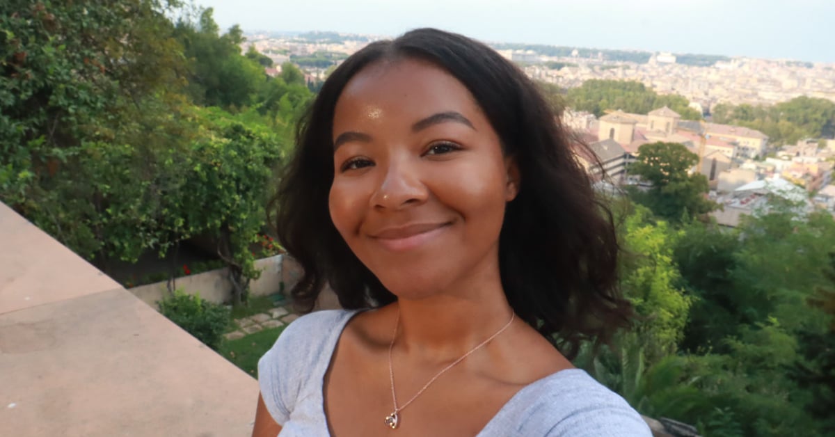 Study abroad student posing in front of famous view of Rome