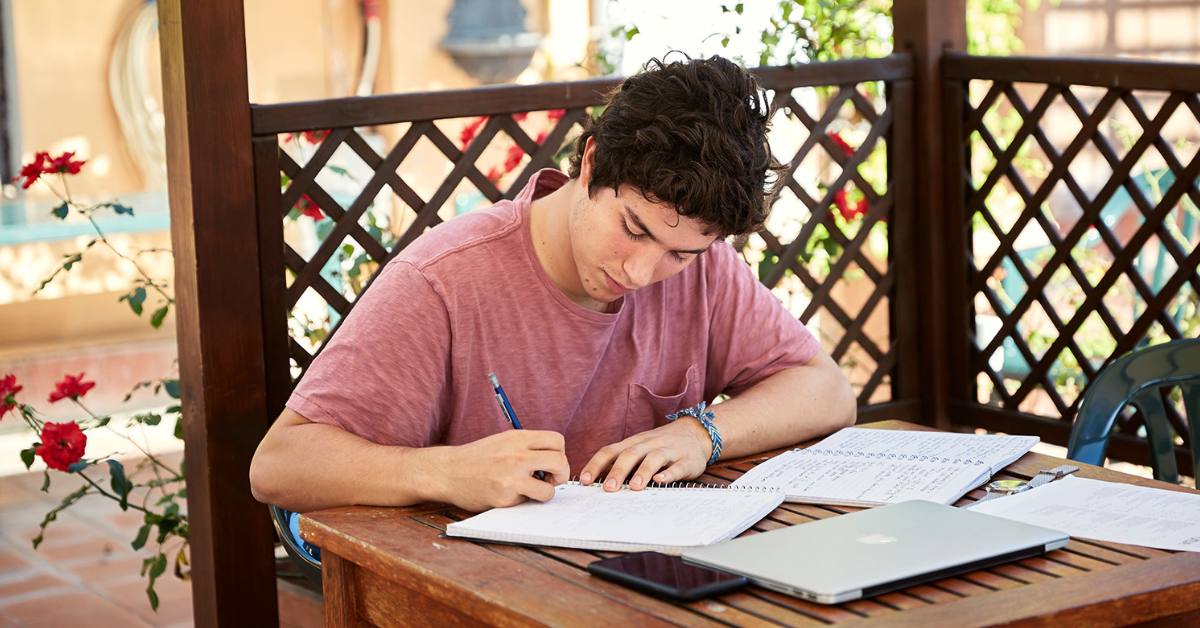 Student studying on the Secchia Terrace at John Cabot University