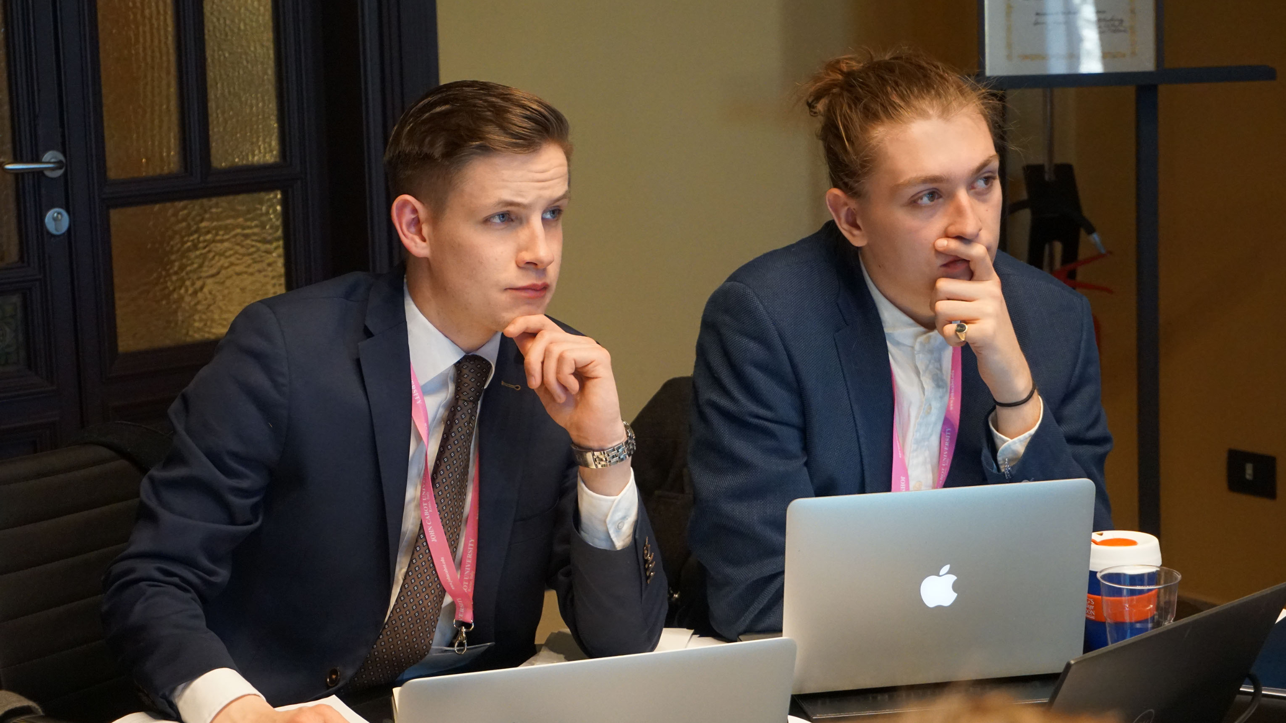 Boys staring away intently while in a meeting