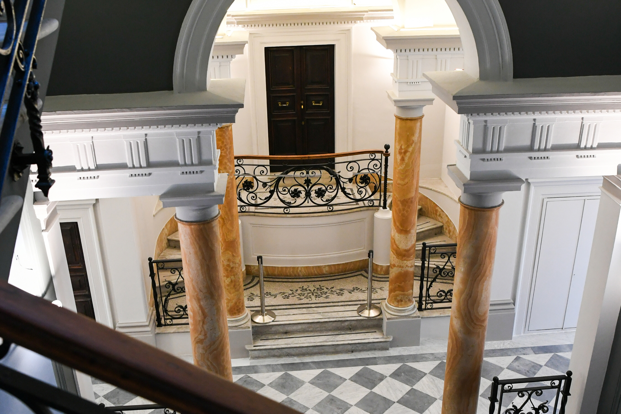 image of building in rome, italy with orange pillars and checkered floors like a 1950s dining room