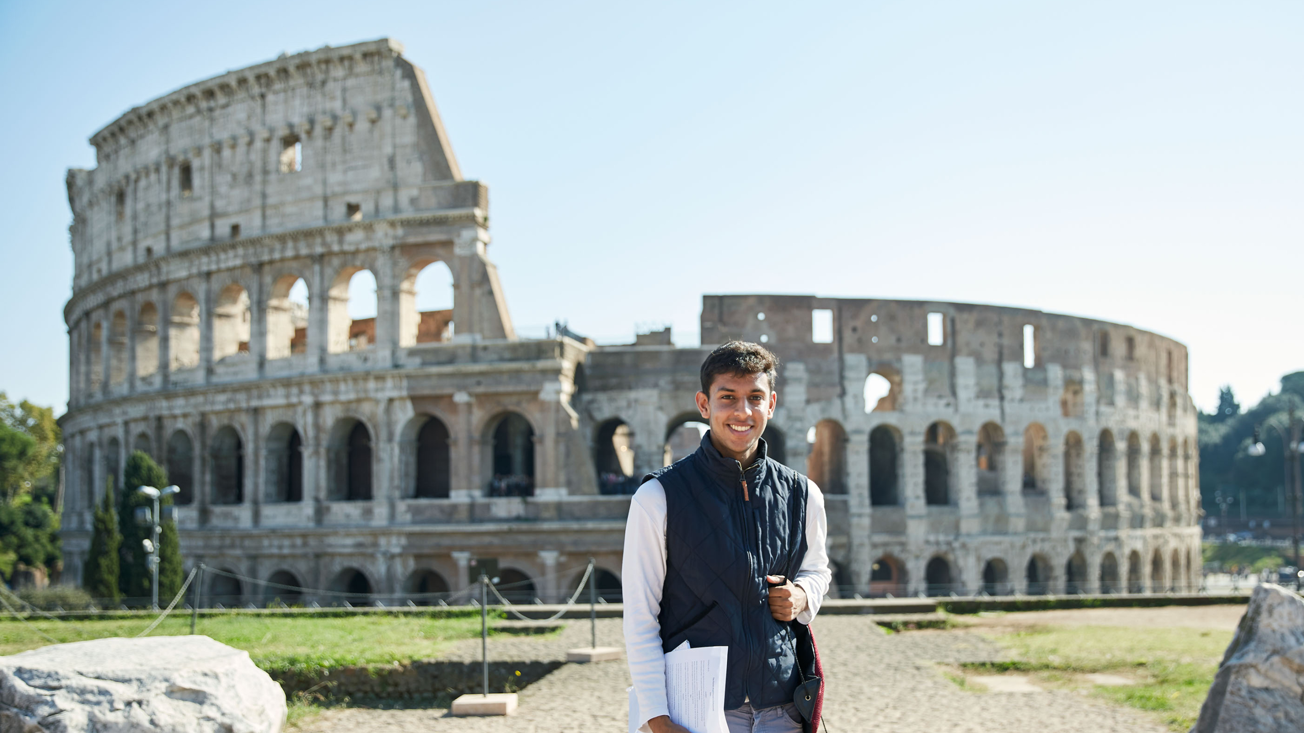 Study abroad student standing in front of the colloseum in Rome