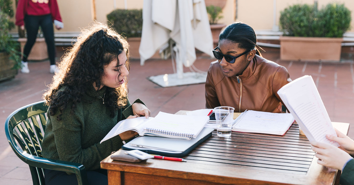 Two girls sitting at a table studying