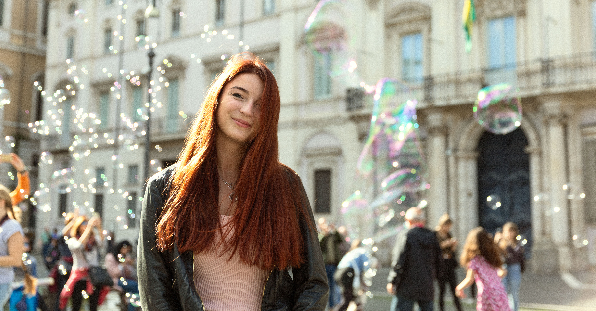 Student standing in front of bubbles in Piazza Navona