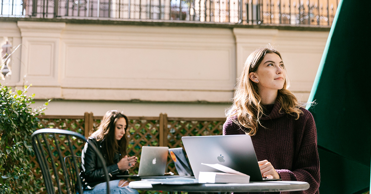 A student studying in the courtyard