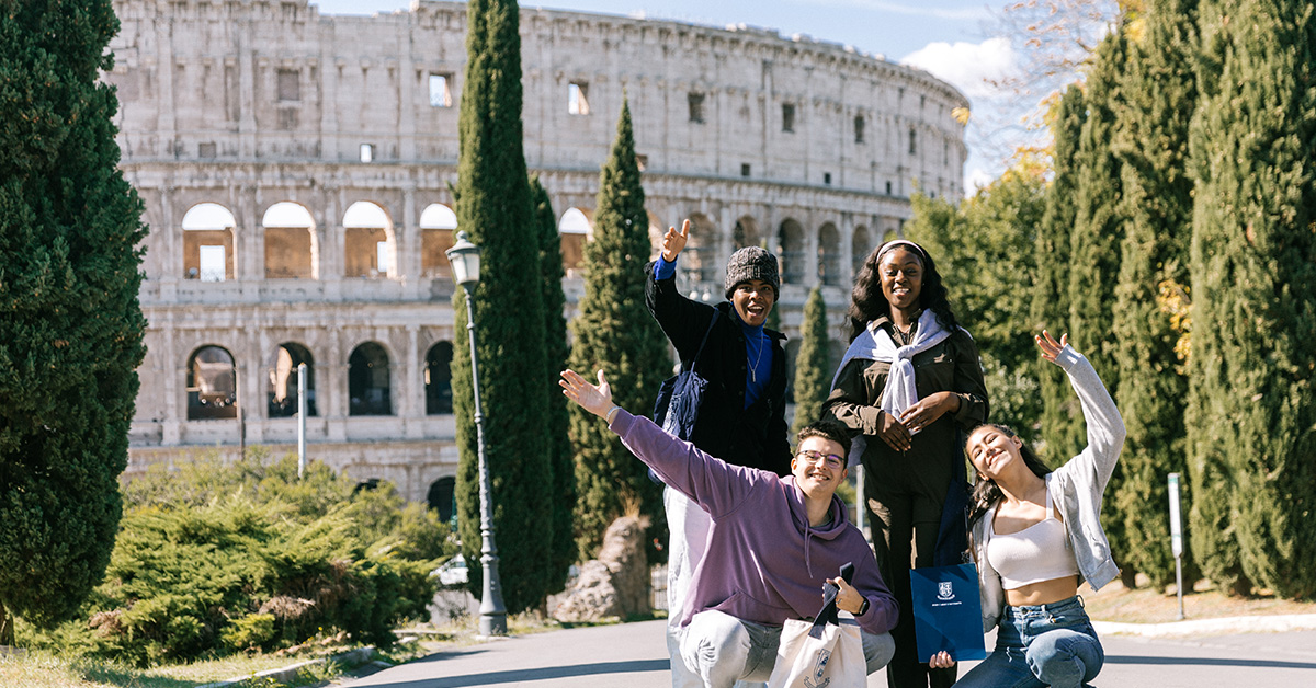 4 students in front of the Colosseum