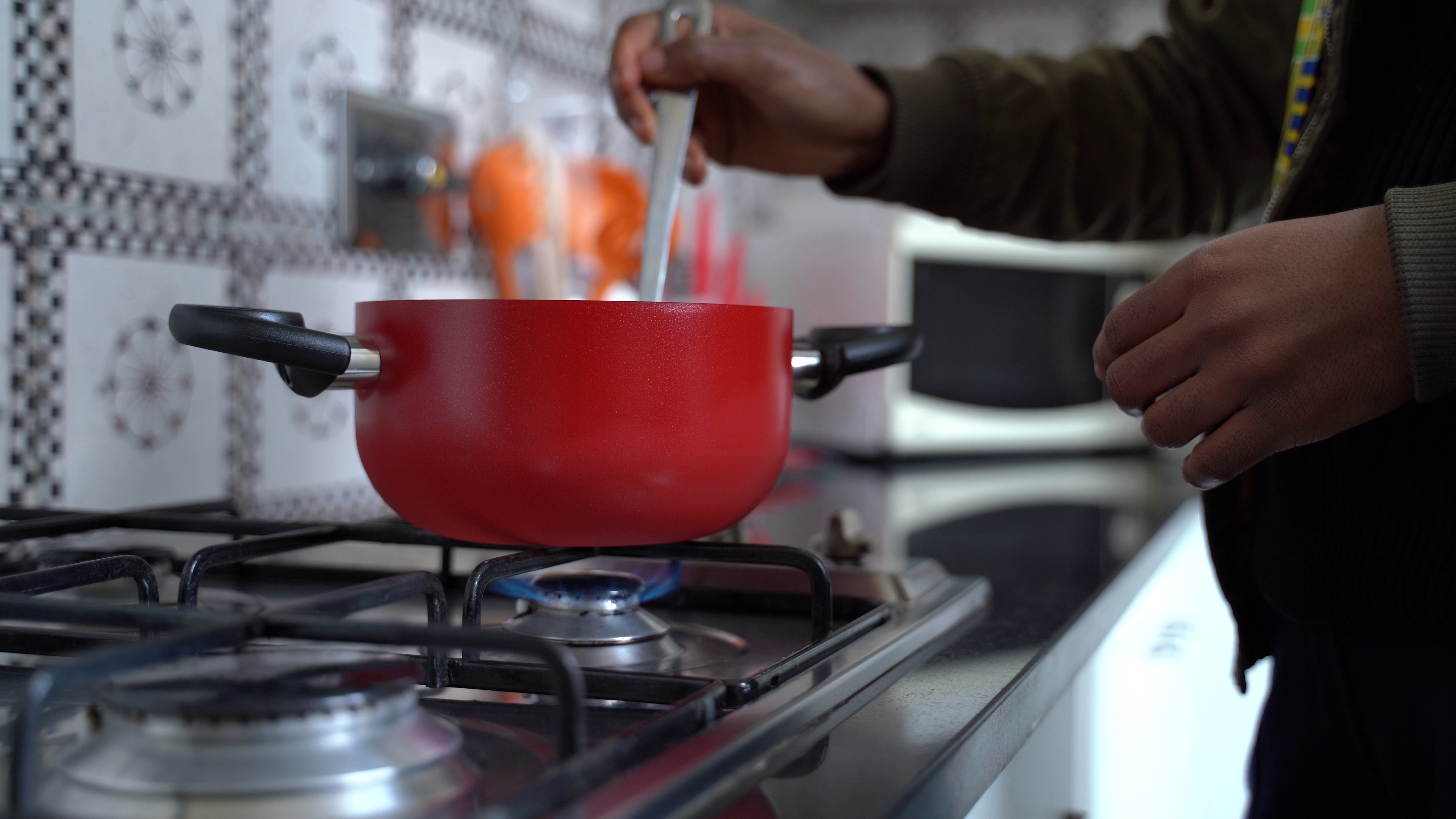 Student cooking in her kitchen in the JCU dorms