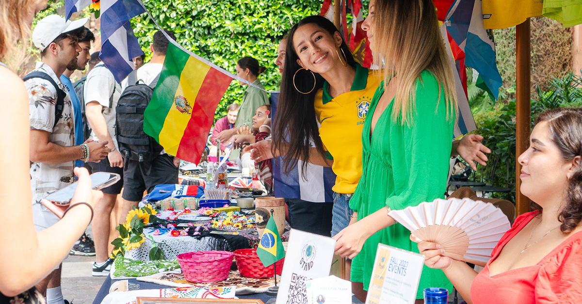 A group of JCU students in front of a table promoting a club.