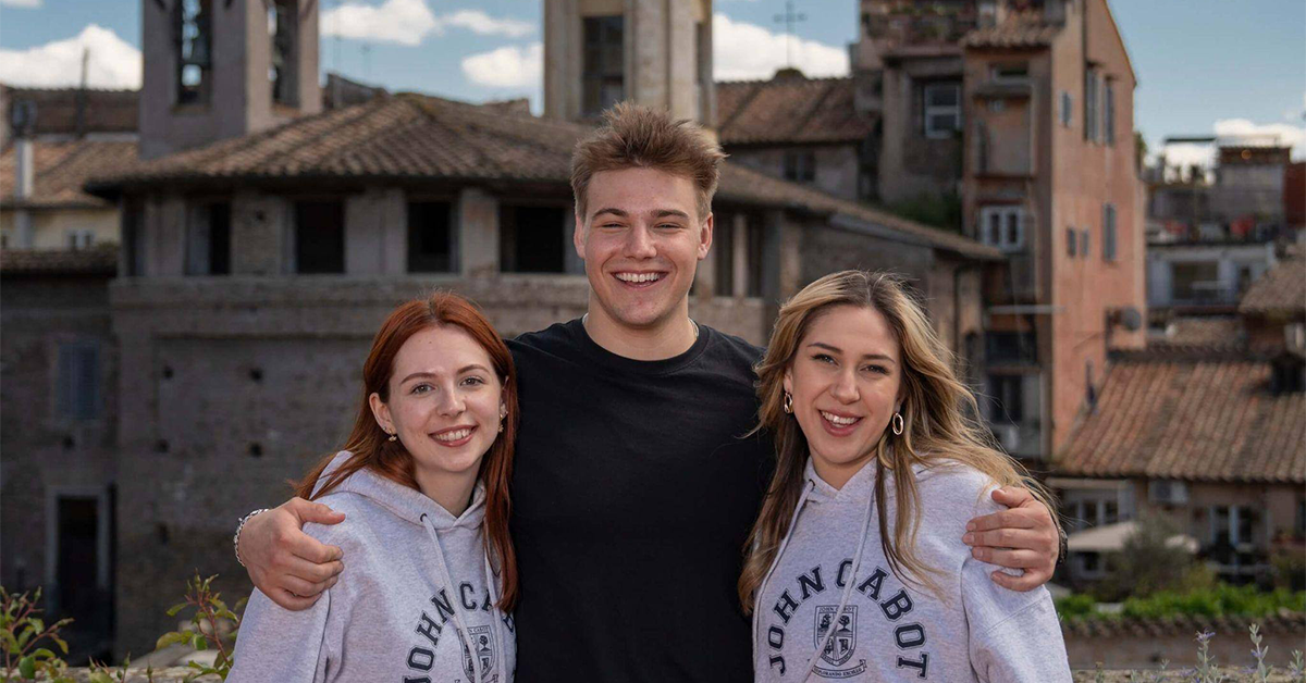 A trio of Institute for Entrepreneurship students posing outside on a break