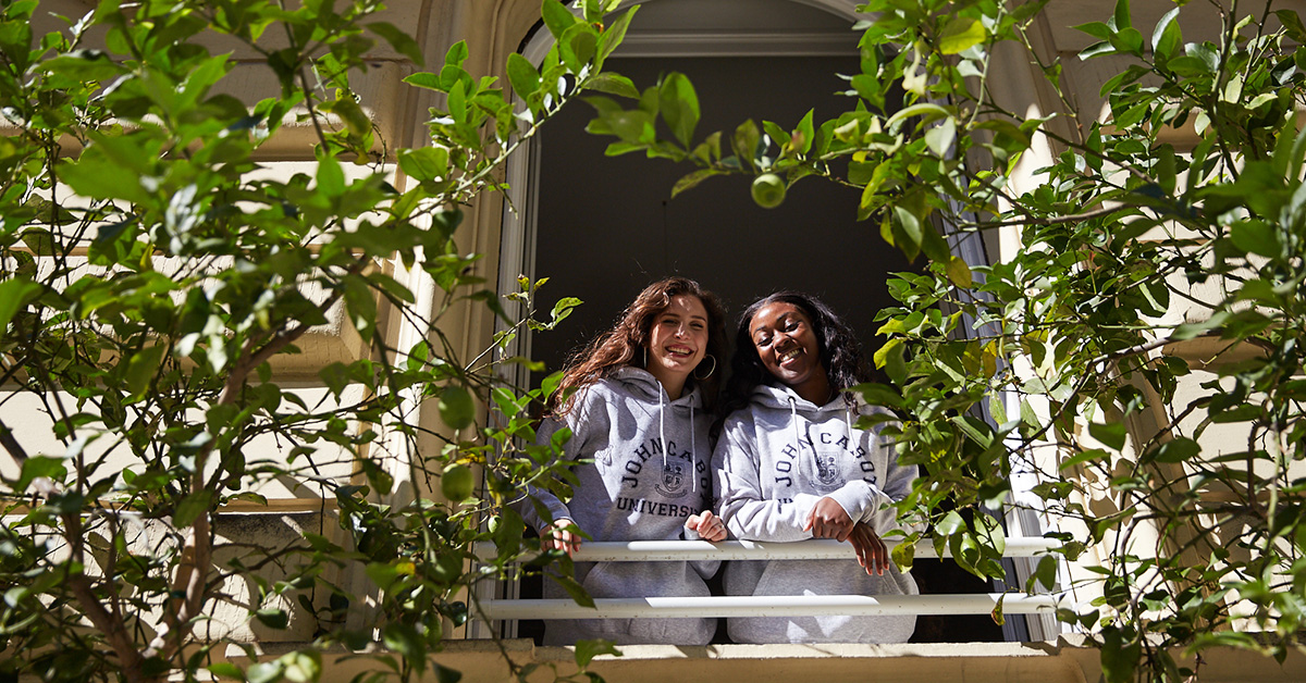 Happy students looking out the window as they study abroad in Italy