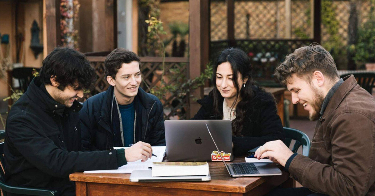 A group of psychology degree students studying outside as a group