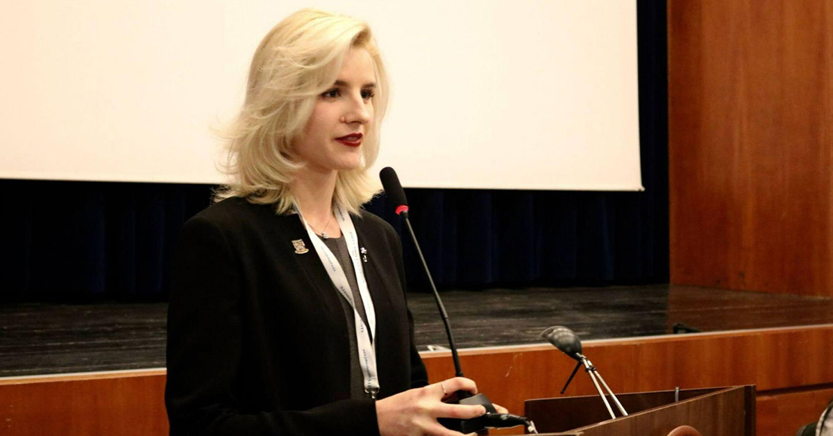 student speaking in front of an audience as they study communications in Rome