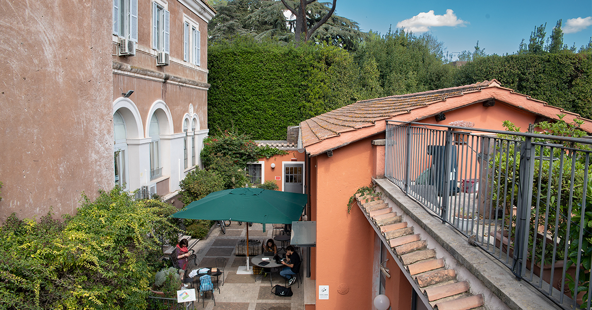 A shot of JCU campus with students studying outside