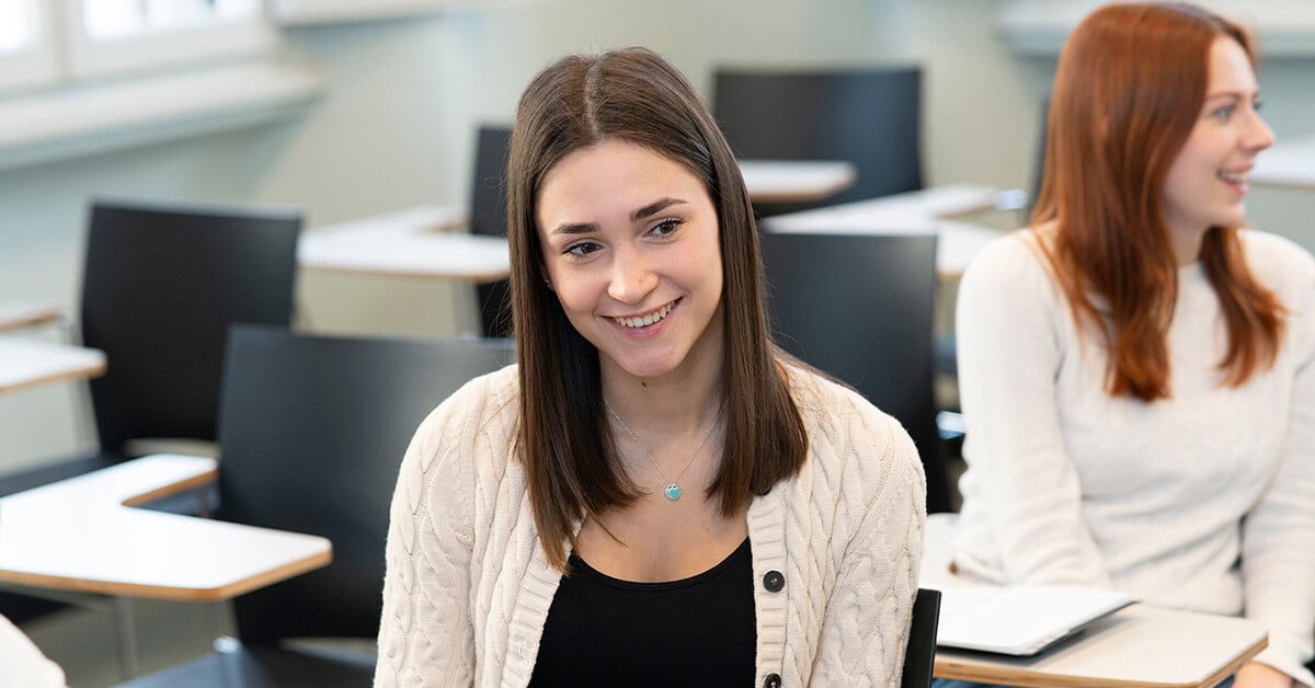 A JCU student smiling in a classroom